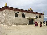Tibet Kailash 07 Manasarovar 05 Trugo Gompa Outside The Hindu poet, Kalidasa, wrote in the 4C: �When the earth of Manasarovar touches anyone�s body or when anyone bathes therein, he shall go to the paradise of Brahma, and who drinks its water shall go to the heaven of Shiva and shall be released from the sins of 100 births.� On the south shore of Lake Manasarovar, the Gelugpa Trugo (Bathing Head) Gompa is named for its importance as a place for ritual bathing by Hindus. Hindus immerse themselves totally in the icy water, while Tibetans simply splash water on their heads and drink the water.